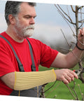 Man wearing Heavy Duty Aramid Arm Guards For Women, Badass Forearm Shields For Gardening And Yard Work, Cut Resistant Sleeves That Shut Out Thorns, Top Notch Outdoor Armor You Gonna Love while pruning branches.