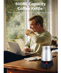 Man enjoying coffee beside Electric 600ml Do It All Coffee Pot With Stainless Steel Kettle And Ergonomic Handle For Home Use