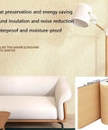 Stress Free Peel And Stick Wallpaper Roll, Removable Self Adhesive Vinyl With Thick Insulation Backing, DIY Accent Wall Glow Up For Laidback Home Vibes, Soft Pink Concrete Texture, Nine Millimeter applied on a modern white sofa with lamp.