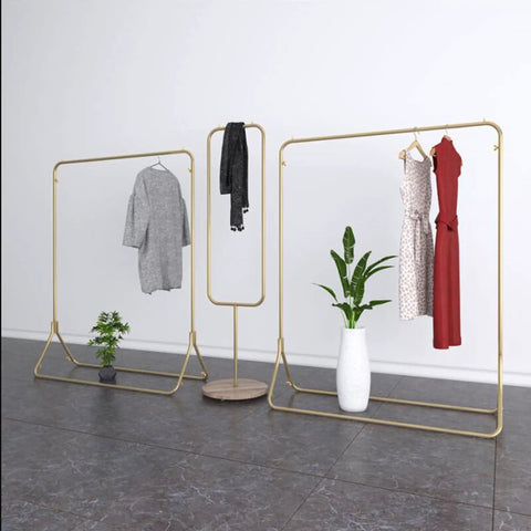 Heavy Duty Iron Coat Rack With Gold Pipe Finish, Boss Level One Pole Floor Stand For Coats And Display, 120x40x150 cm shown with plants