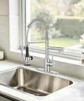 BDJM Kitchen Faucets with Pull Down Sprayer,NEW1 in brushed nickel finish beside a stainless steel sink.