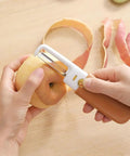 Person using Stainless Steel Fruit Peeler Knife For Kitchen And Camping Use, Portable Double Head With Orange Handle to peel apple