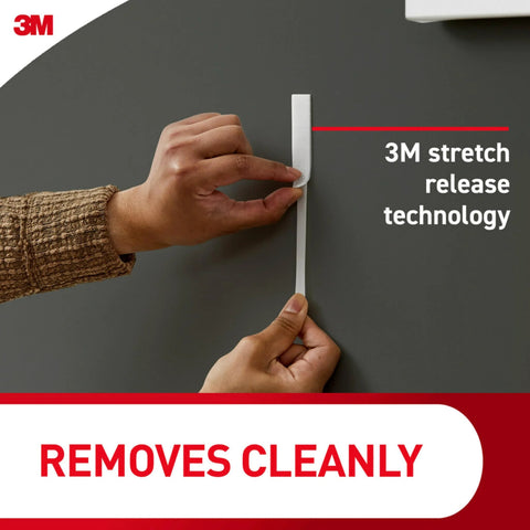 Demonstrating 3M stretch release technology for clear variety pack for damage free hanging, shows easy strip removal from wall