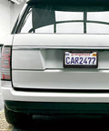 Matte Black License Plate Frame Set For Your Ride, 2 Hole Solid Aluminum Car Plate Holder, attached on white SUV rear
