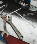 Heavy Duty T Handle Socket Wrench Set For Bike And Motorcycle Maintenance With Thick Hexagon Shaft and wrenches on a workbench.