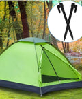 Green tent on grass with inset image of two black plastic stakes, 24 Pack 5.7 Inch Plastic Tent Stakes For Tents And Canopies.