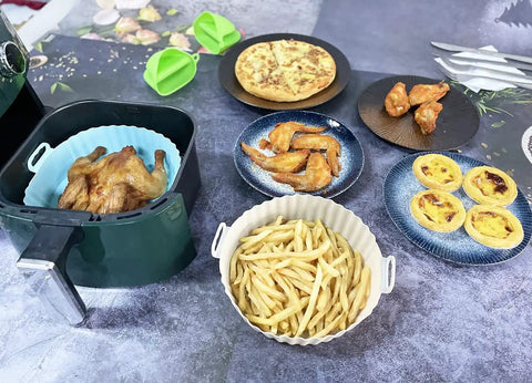 Image showing a 7.5 Inch Round Air Fryer Silicone Liner with food like roasted chicken, fries, and pastries for easy cleanup.