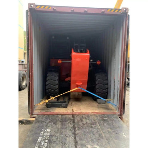 Heavy Duty Telehandler Telescopic Reach Forklift With Enclosed Cab inside a shipping container, ready for transport.