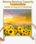 Two people hanging a sunflower painting with Beefy 372 Piece Picture Hanging Kit With Nails Sawtooth Hangers Hooks Ring Holes.