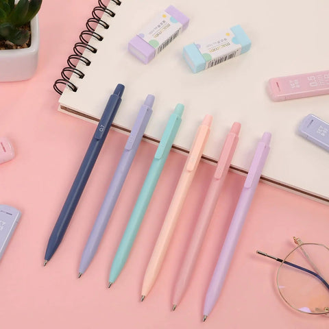All-In-One Student Stationery Kit With Pencil Case, 12 Pastel Highlighters, 5 Black Gel Pens, Mechanical Pencils, Sticky Note Pad, Erasers, And More Pink School Supplies Set For College And Back To School with pastel pens and erasers on pink background