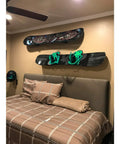Rock Hard Premium Aluminum Snowboard Wall Mount Rack With Grippy Eva Padded Skis Display Hanger For Garage Home Storage Heavy Duty Brackets Double Pack Set on bedroom wall with snowboards and green bindings.