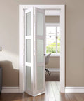 Bifold Closet Door For 24x80 Opening With Tempered Frosted Glass Folding Barn Door Kit installed in room, white finish