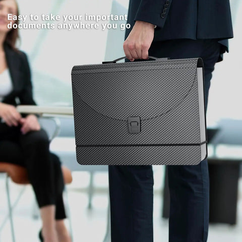 Grab And Go Expandable Accordion File Folder Boasting 25 Roomy Pockets A Heavy Duty Plastic Carry Handle held by a professional.