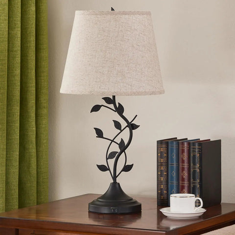 Vintage Tree Branch Base Table Lamp With Beige Shade USB A And USB C Charging Ports Tall Bedroom End Table Lamp For Bedside Or Living Room Retro Yet Modern Look That Elevates Any Decor on wooden table next to books and cup