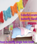 Colorful ceramic butterfly cabinet knobs in child's bedroom decor