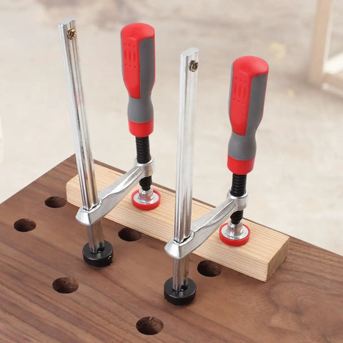 Rock Solid 2 Pack Adjustable Bench Dog Clamps For Three Quarters Inch Dog Holes On MFT Tables Holds Tight For Routing Drilling And Sanding Stable Holdfast Style Woodworking Tools, showing clamps in use on wood.