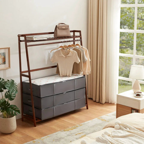 4 Pack Under Bed Storage Containers 95L Large Capacity With Reinforced Handles, neatly stacked under a garment rack in bedroom.