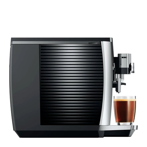 Premium Fully Automatic Chrome Espresso Coffee Machine Featuring A Hella Smooth Four Point Three Inch Smart Touchscreen Display For Twenty Seven Freshly Ground Drinks, side view with cup.