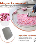 Stainless Steel Ice Cream Shovel With Wooden Handle making pink ice cream rolls on a cold plate, showing blade and rolled ice cream.