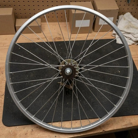 Slick Single Speed Rear Wheel Rim With Heavy Duty Aluminum Hub And Plug In Brake Assembly For No Sweat Bike Repair and Rock Solid Stopping Power Built To Roll All Week Long, 26 inch silver rim.