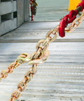Close-up of Three Eighths Inch 20 Foot G80 Tow Chain with grab hooks on metal surface, galvanized manganese steel, 7100 lb WLL
