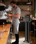 Vertical Electric Espresso Portafilter Cleaner With Knock Box Combo Auto Ground Removal For Home And Cafe Baristas Smooth Daily Grind Cleanup Universal Fit Quick Dump Station showcased in cafe with barista.