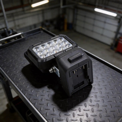 ABS Handheld Flood Light 18V Li-Ion Compatible on a textured surface, showcasing 15 LED lights and battery compartment.