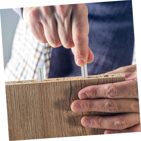 Person installing stainless steel dowel pins into wood, demonstrating 100 Pcs Dowel Pins Set Stainless Steel Cylindrical Fastening Pins for Machinery Electronics Automotive Applications Precision Fit Corrosion Resistant Easy Installation and High Stability to Prevent Loosening.