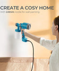 Snag This Featherweight Electric Paint Sprayer With A Quick Swap Cup And 20 Oz Capacity For Dead Simple Cabinet Fence Door And Wall Painting Jobs That Fly Off In A Snap Keeps Your Hands Fresh, showing user holding sprayer against wall.