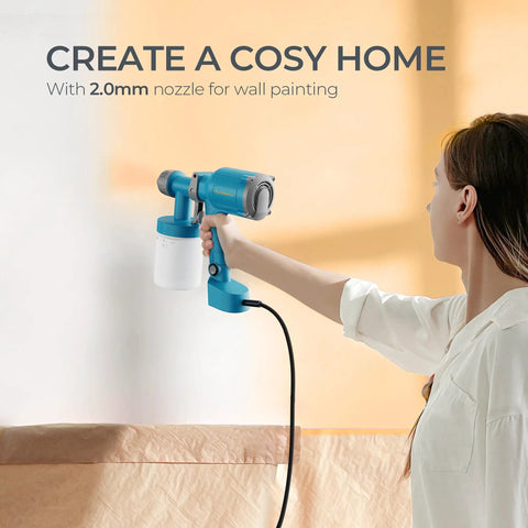 Snag This Featherweight Electric Paint Sprayer With A Quick Swap Cup And 20 Oz Capacity For Dead Simple Cabinet Fence Door And Wall Painting Jobs That Fly Off In A Snap Keeps Your Hands Fresh, showing user holding sprayer against wall.
