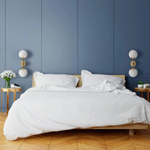Celestia 2-Light Wall Sconce In Matte Brass With Frosted Glass Shades For A Modern Glam Vibe And Soft Cozy Glow In Living Rooms, Halls, Or Bedrooms And More in a stylish bedroom setting