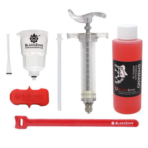 Shimano Hydraulic Brake Bleed Kit with 120ml mineral oil, pro syringe, funnel, and tools for DIY maintenance on mountain bikes.