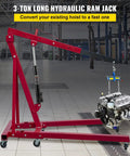 Red 3-ton hydraulic long-ram jack with clevis base and manual handle lifting a car engine on a shop hoist in a workshop