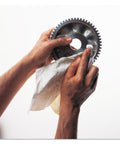 Hands using PowerClean X70 Medium Duty Cloths Quarterfold Wipes For Industrial Cleaning on a gear to remove grime and oil