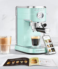 Compact Stainless Steel Espresso Machine With Powerful Steam Wand For Killer Lattes And Smooth Shots At Home next to a glass of espresso.