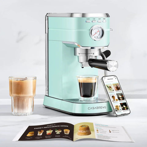Compact Stainless Steel Espresso Machine With Powerful Steam Wand For Killer Lattes And Smooth Shots At Home next to a glass of espresso.