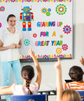 Teacher with robot bulletin board set and text 'Gearing Up For A Great Year' Gear Up Your Classroom With 52 Piece Robot Bulletin Board Set