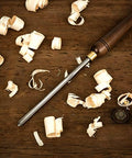 Badass Three Piece Bowl Gouge And Wood Chisel Set For Exact Lathe Work on wooden surface with wood shavings.