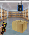 Heavy Duty Electric Chain Hoist, 1100 Lb Capacity With 1800 Watt Motor lifting a box with dual remote control in a storage area.