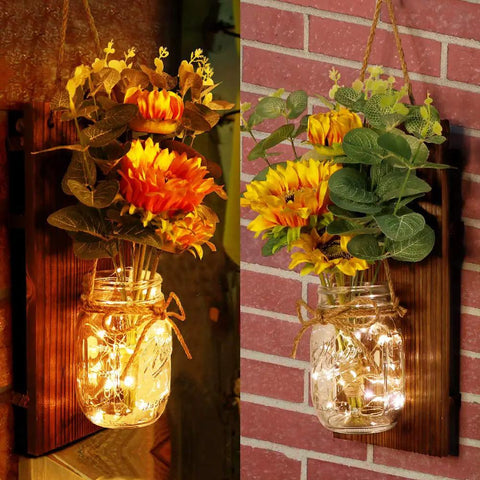 Set Of Two Sunflower Mason Jar Wall Sconces With Remote Control in warm LED glow on wood boards, farmhouse wall decor displayed.