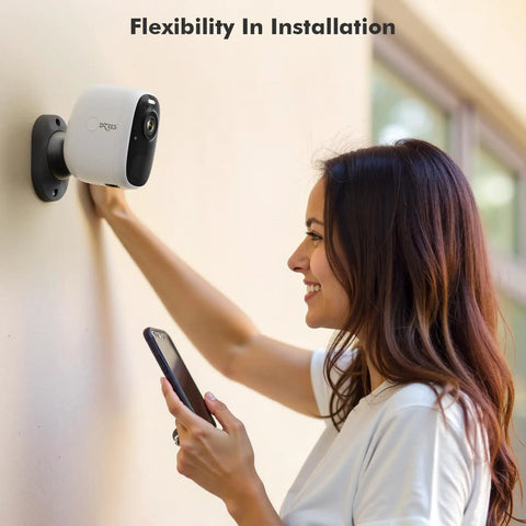 Person installing 4MP Solar Security Camera Outdoor Wire Free Wireless Camera With 360 Degree Rotating Magnetic Mount on wall.