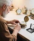 Craftsman using Compact 11 Piece Precision Screwdriver Set For Watch, Eyeglasses, And Electronics Repair with clocks in background