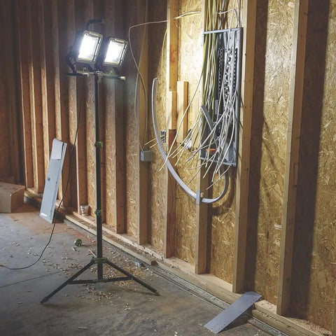 20,000 Lumen Dual Head LED Work Light With Adjustable Tripod, 9 Ft Cord illuminating construction site with exposed wiring