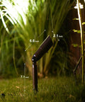 Single spotlight from 8 Pack Low Voltage Landscape Lighting Kit That Lights Up Your Yard, 3W LED Bulbs, showing 7.1 inch height in garden.