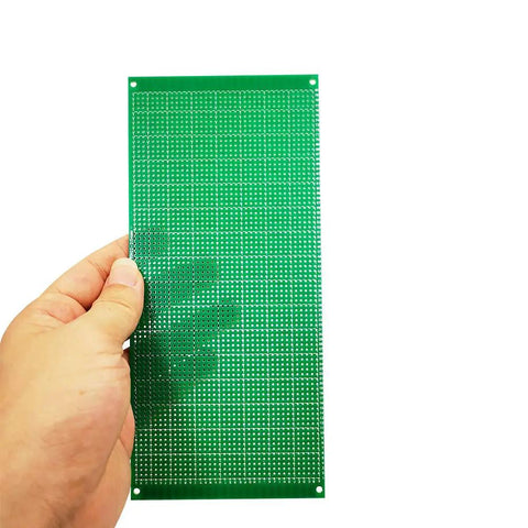 Hand holding a 10x22 cm tin-plated PCB board from 11 Piece Large PCB Board Kit In 4 Sizes 10X22 Cm, 15X9 Cm, 9X7 Cm And 7X5 Cm Blank Prototype Boards