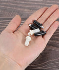 Kickass Spring Loaded Plantation Shutter Repair Pins For Window Louvers 50 Pack Metal Replacement Hardware in hand with black and white pins.