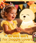 Young girl in a yellow dress holding Cute Puppy Night Light For Kids With 16 Colors And Dual Brightness Levels 30 And 60 Minute Timer Soft Silicone Nursery Lamp Rechargeable 1200mAh 10 Hours Use Kid Approved Room Decor Gift For Boys And Girls