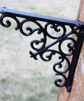 Built Tough Heavy Duty Cast Iron Wall Shelf Brackets Rust Proof 90 Degree Corner Braces detailed view of ornate black metal bracket.