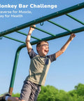 Child enjoying Backyard Swing Set Built Tough With Monkey Bars Trapeze Bar And Two Belt Swings Heavy Duty Metal Playground For Kids Outdoor Jungle Gym In Green And Brown Weather Resistant Powder Coated Steel.