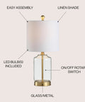 Brass Gold And Clear Glass Table Lamp With White Linen Drum Shade showing LED bulb and on/off rotary switch